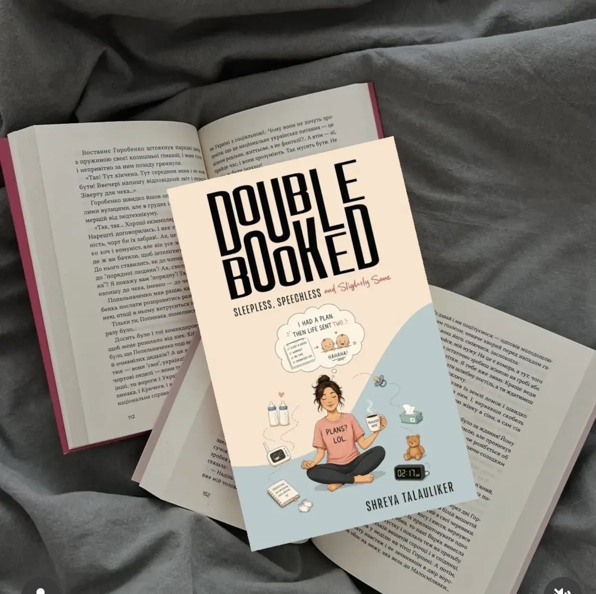 Double Booked photographed among other books