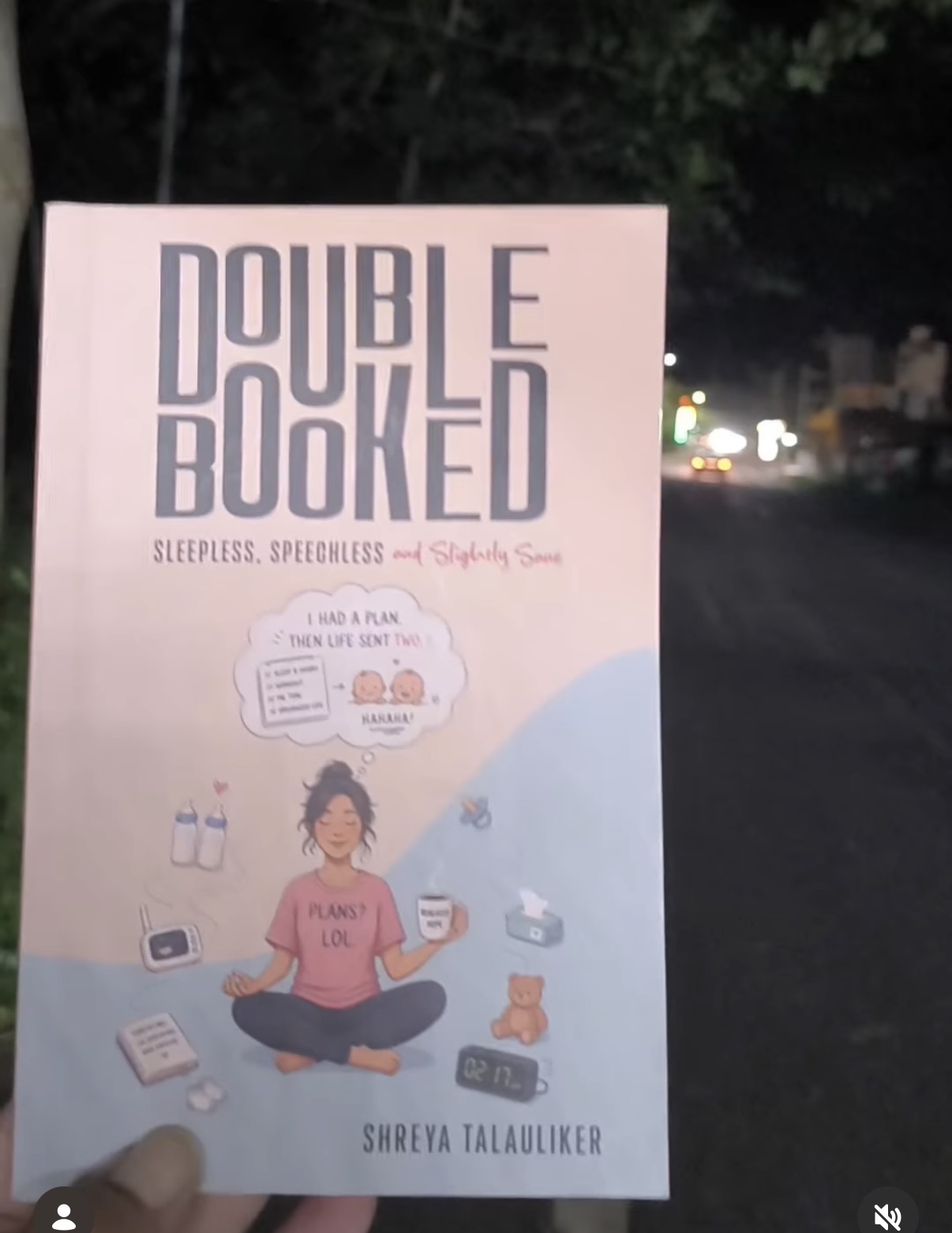 Reader sharing a copy of Double Booked outdoors