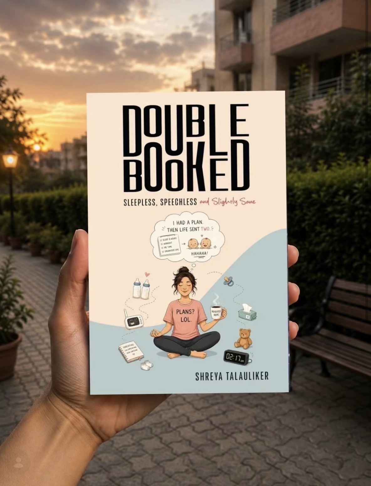 Reader holding Double Booked at sunset